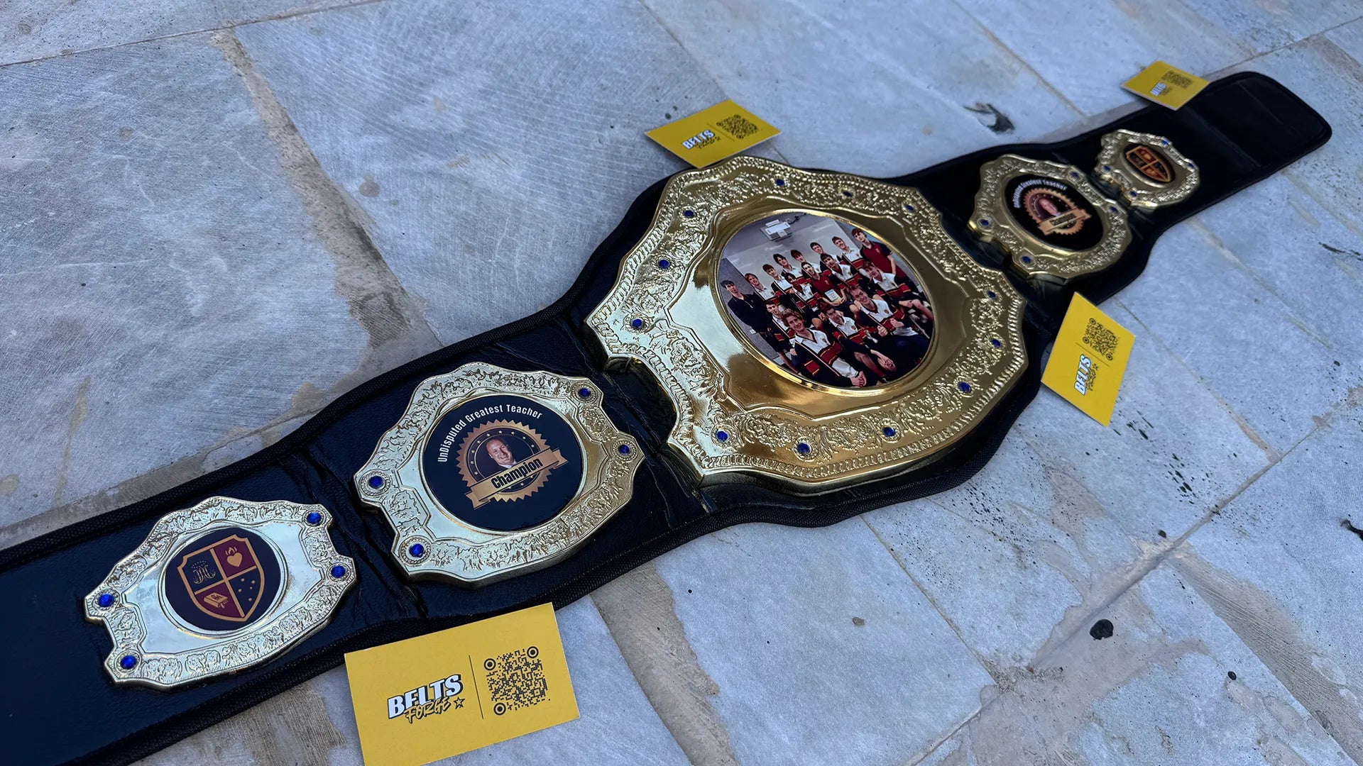 Custom Greatest Teacher Championship Belt angled right profile showing center plate with team photo