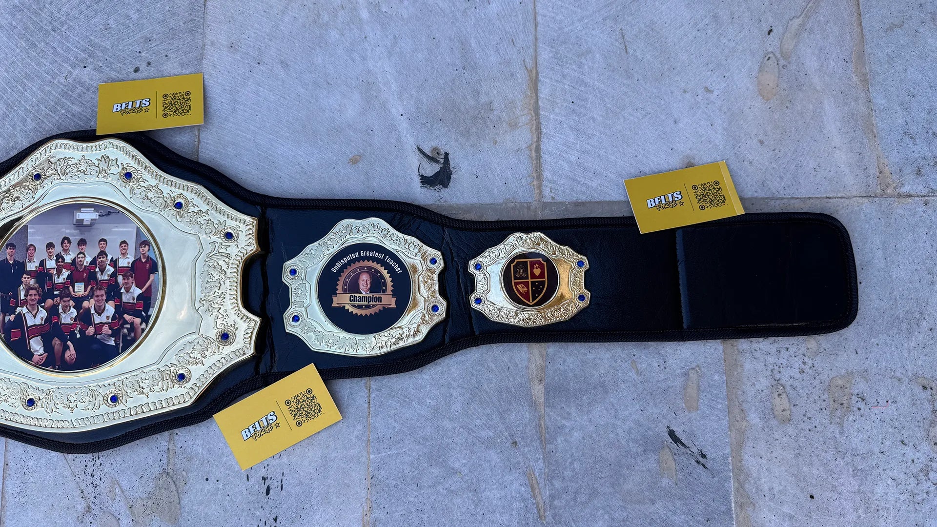 Custom Greatest Teacher Championship Belt right strap center and side plates angled view