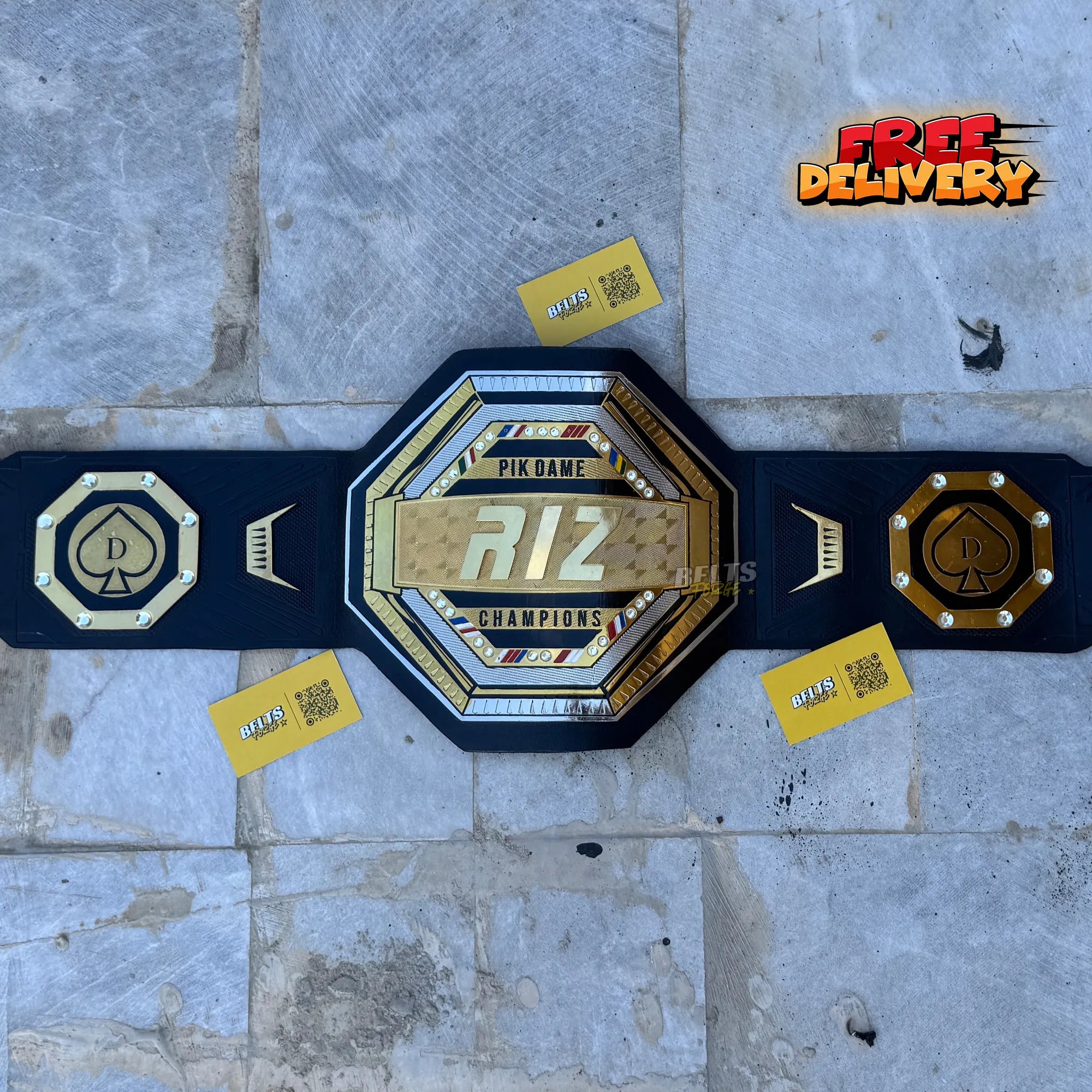 Custom UFC style championship belt promotional front view flat lay showing octagon center plate by Belts Forge