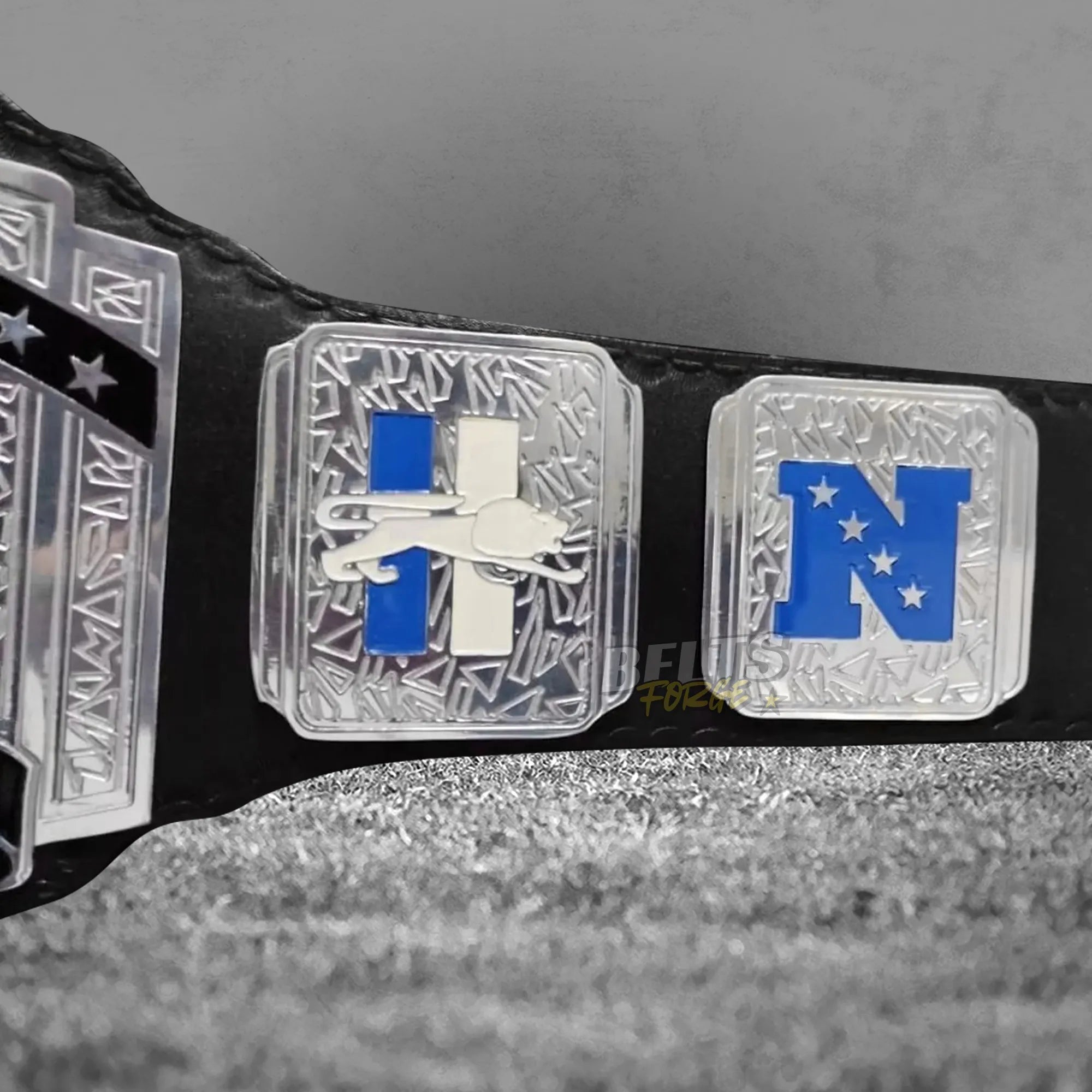 Detroit Lions championship belt NFC side plate detail showing gold-plated brass NFC plate on Honolulu blue leather strap