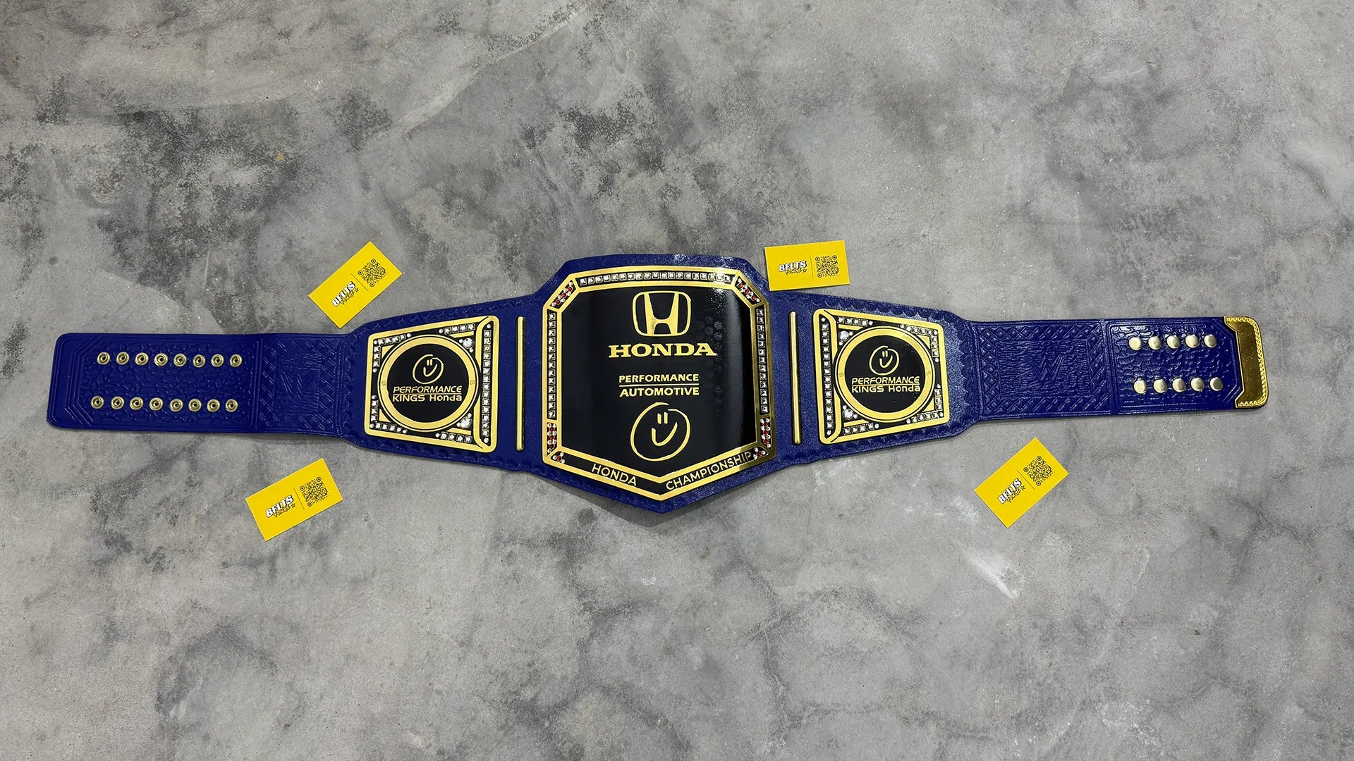 Honda Performance Kings Dealership Championship Belt full flat lay display view showing complete gold-plated plates on blue leather strap