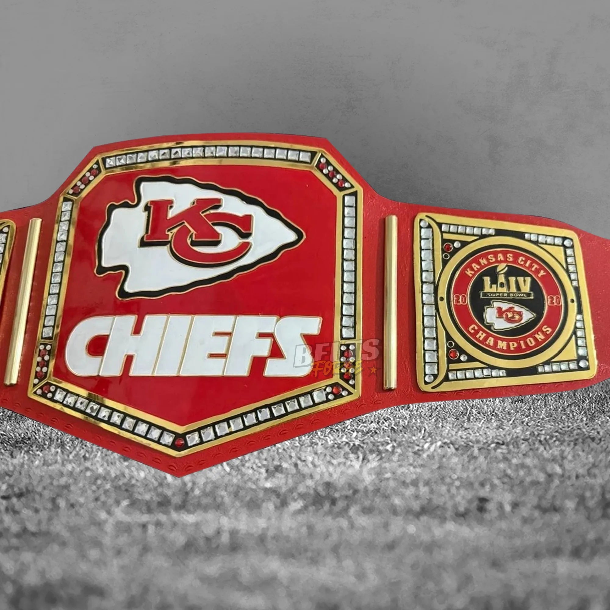 Kansas City Chiefs championship belt center and side plate close-up showing gold-plated brass Chiefs and AFC plates on red leather