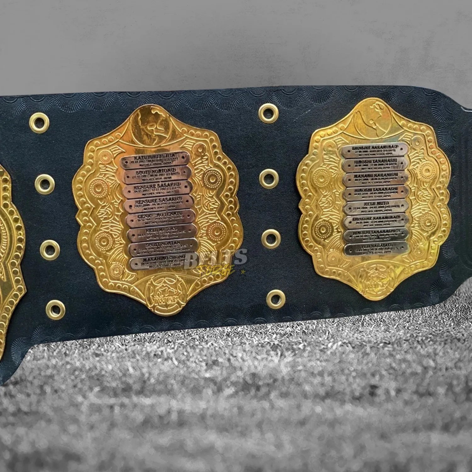 NJPW IWGP Heavyweight Championship Classic Belt left side plate detail showing engraved champions list on gold-plated brass