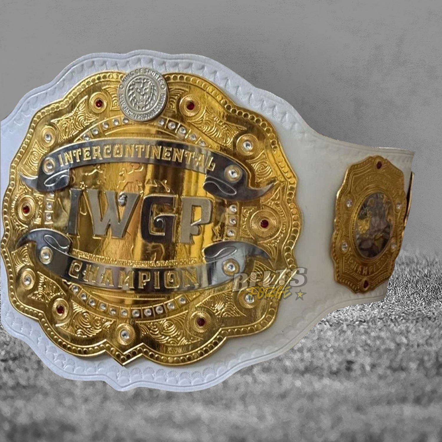 NJPW IWGP Intercontinental Championship Belt angled front view with side plate showing gold-plated brass design on white leather