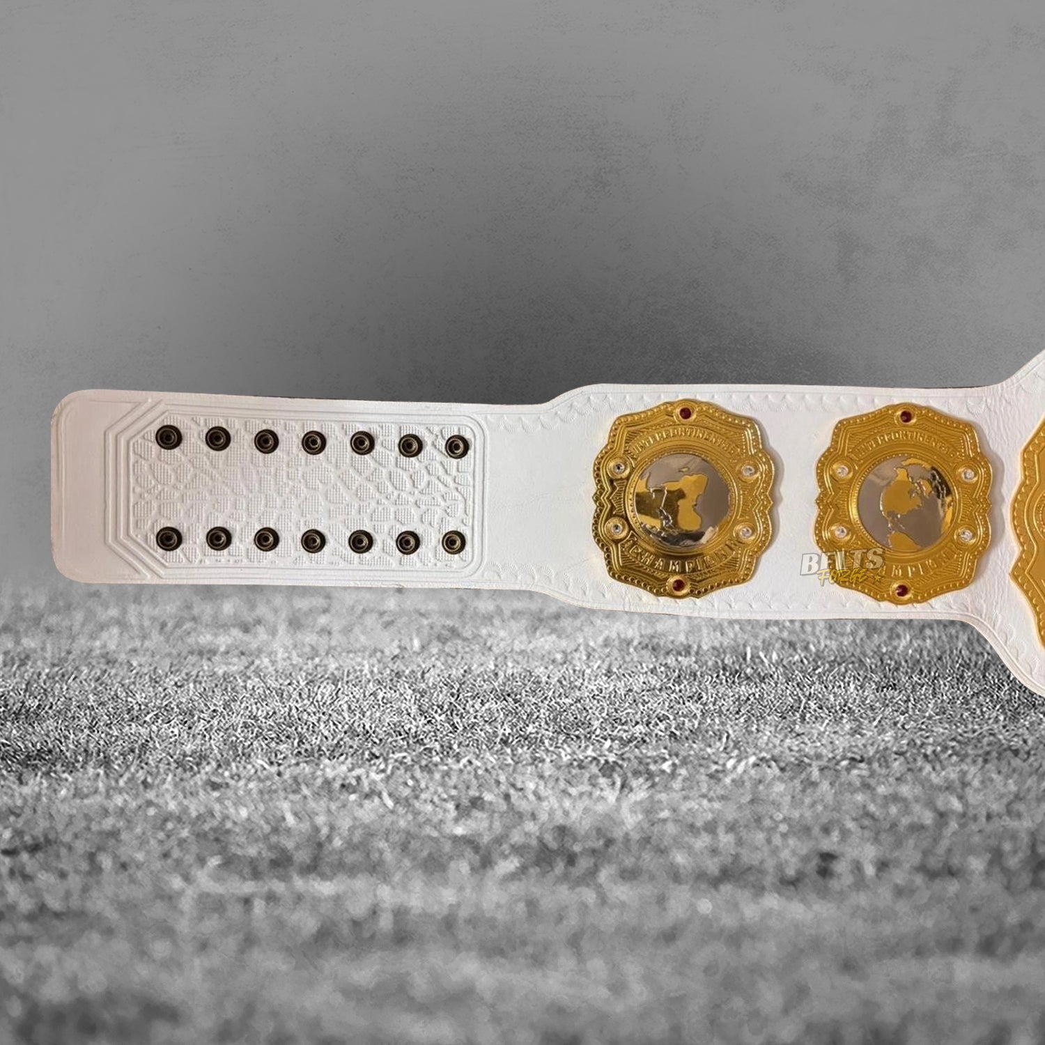 NJPW IWGP Intercontinental Championship Belt left strap end and side plates detail showing gold-plated brass on white leather strap