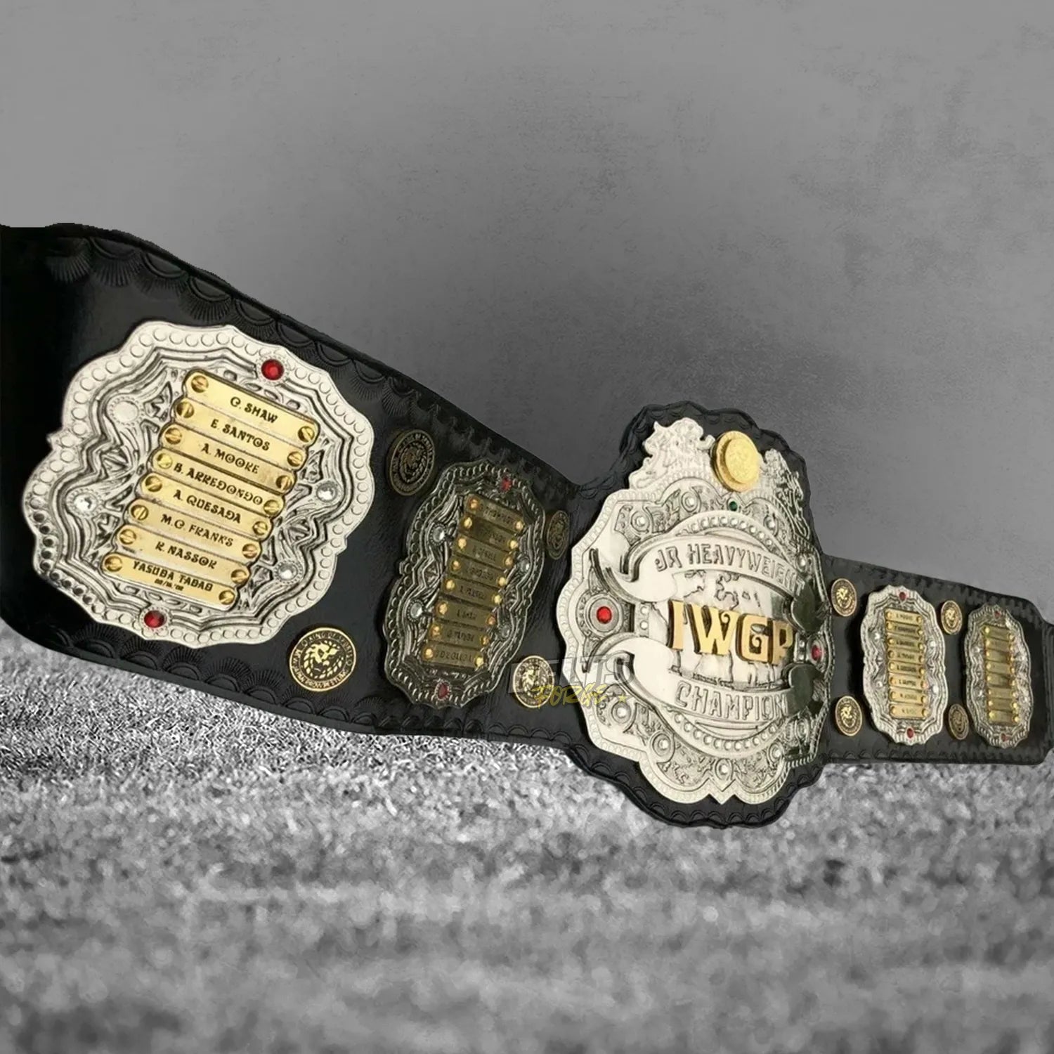 NJPW IWGP Junior Heavyweight Championship Belt left side plate and center angled view showing CNC-engraved gold-plated brass detail