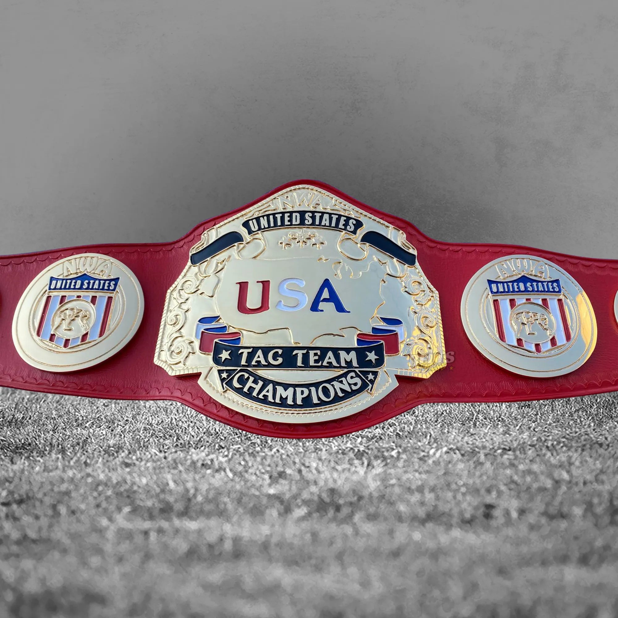 NWA USA Tag Team Championship Belt strap rivet and medallions detail showing gold-plated NWA brass medallions on genuine red leather