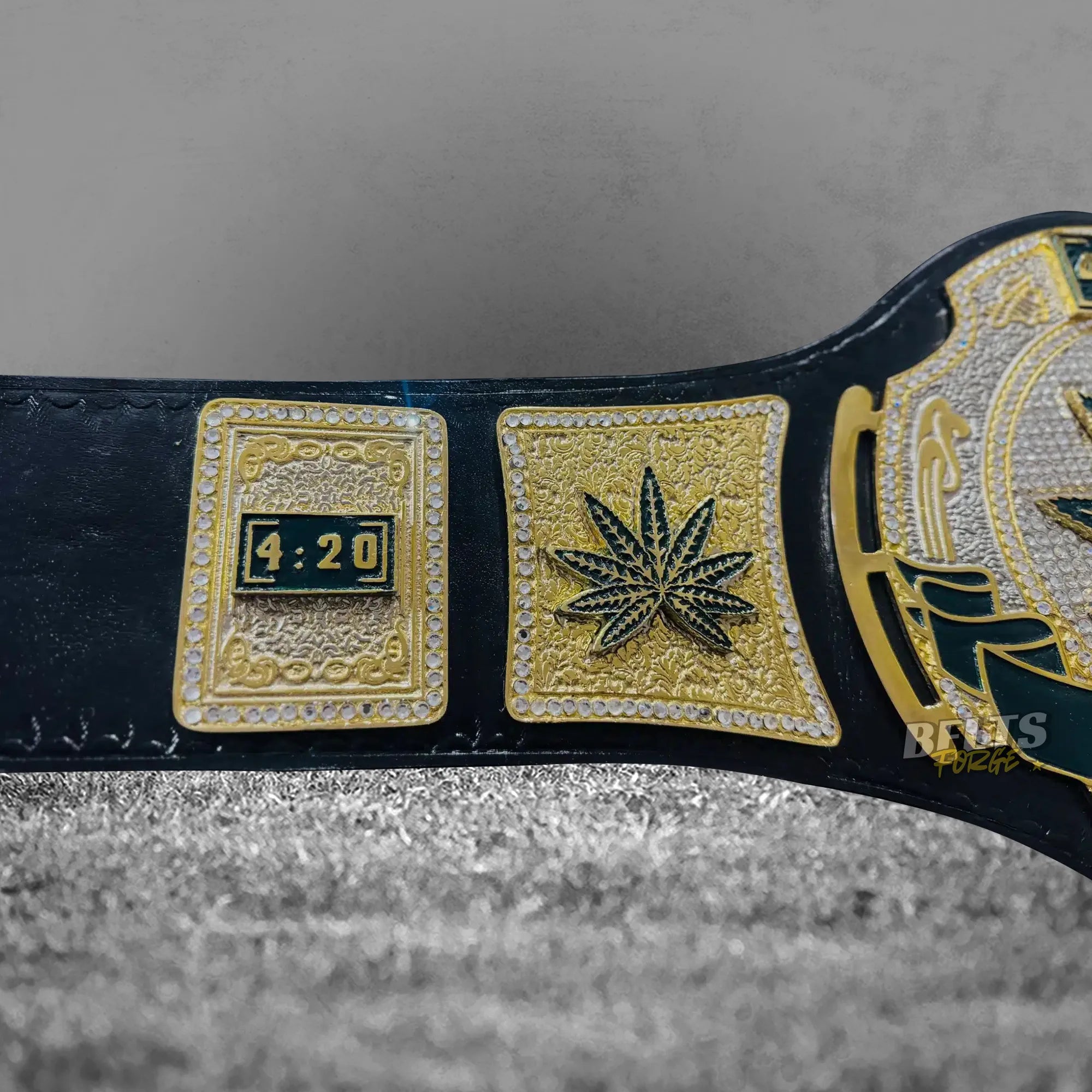 Stoner 420 Championship Novelty Belt center plate close-up showing CNC-engraved gold brass 420 novelty championship design