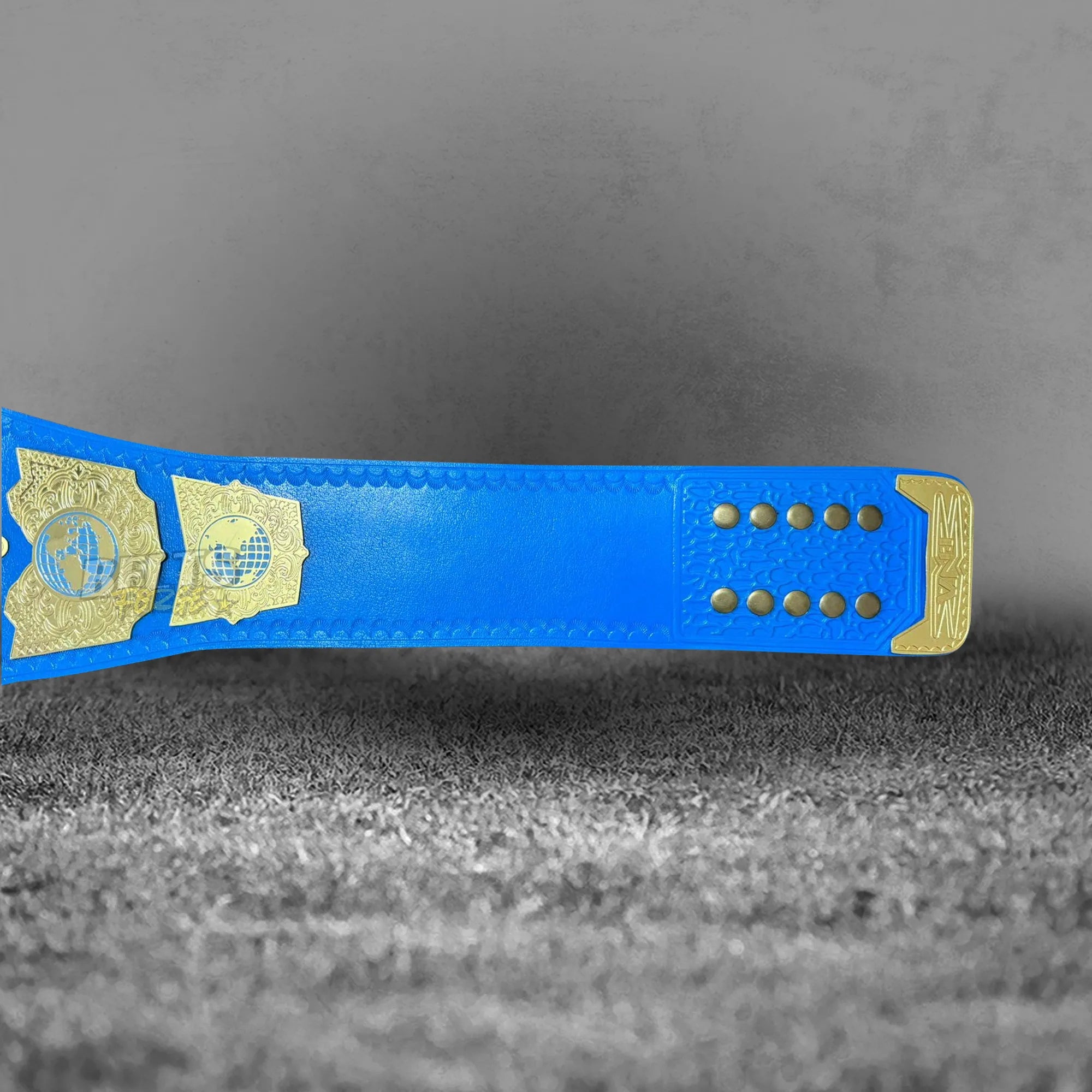 TNA International Championship Belt strap underside back detail showing genuine blue leather strap texture and gold hardware