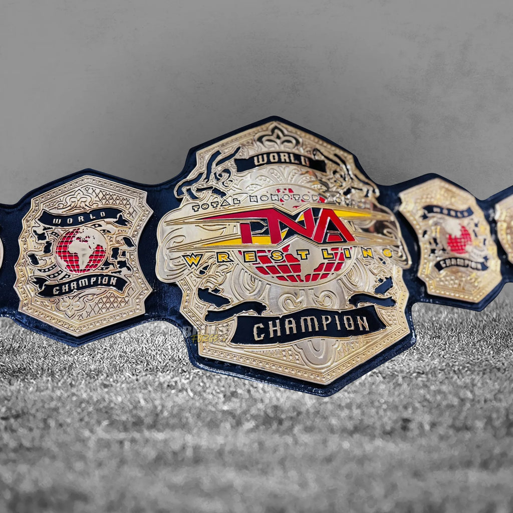 TNA World Heavyweight Championship Belt center plate close-up showing CNC-engraved gold TNA globe and world championship detail