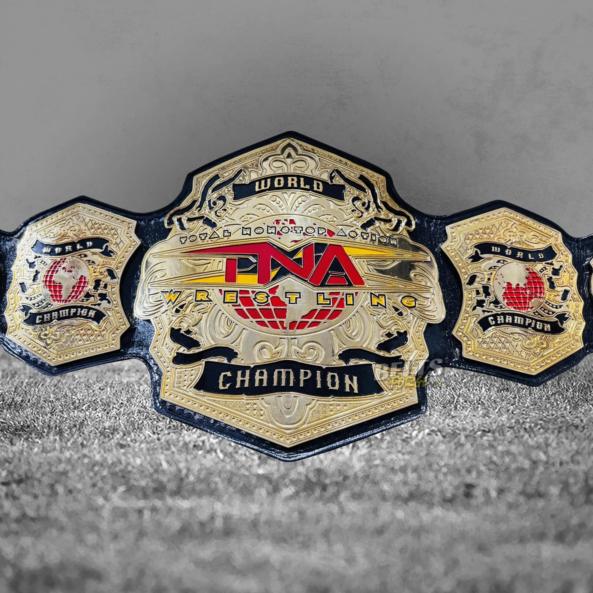 TNA World Heavyweight Championship Belt full front display view showing gold TNA globe main plate and Anthem side plates
