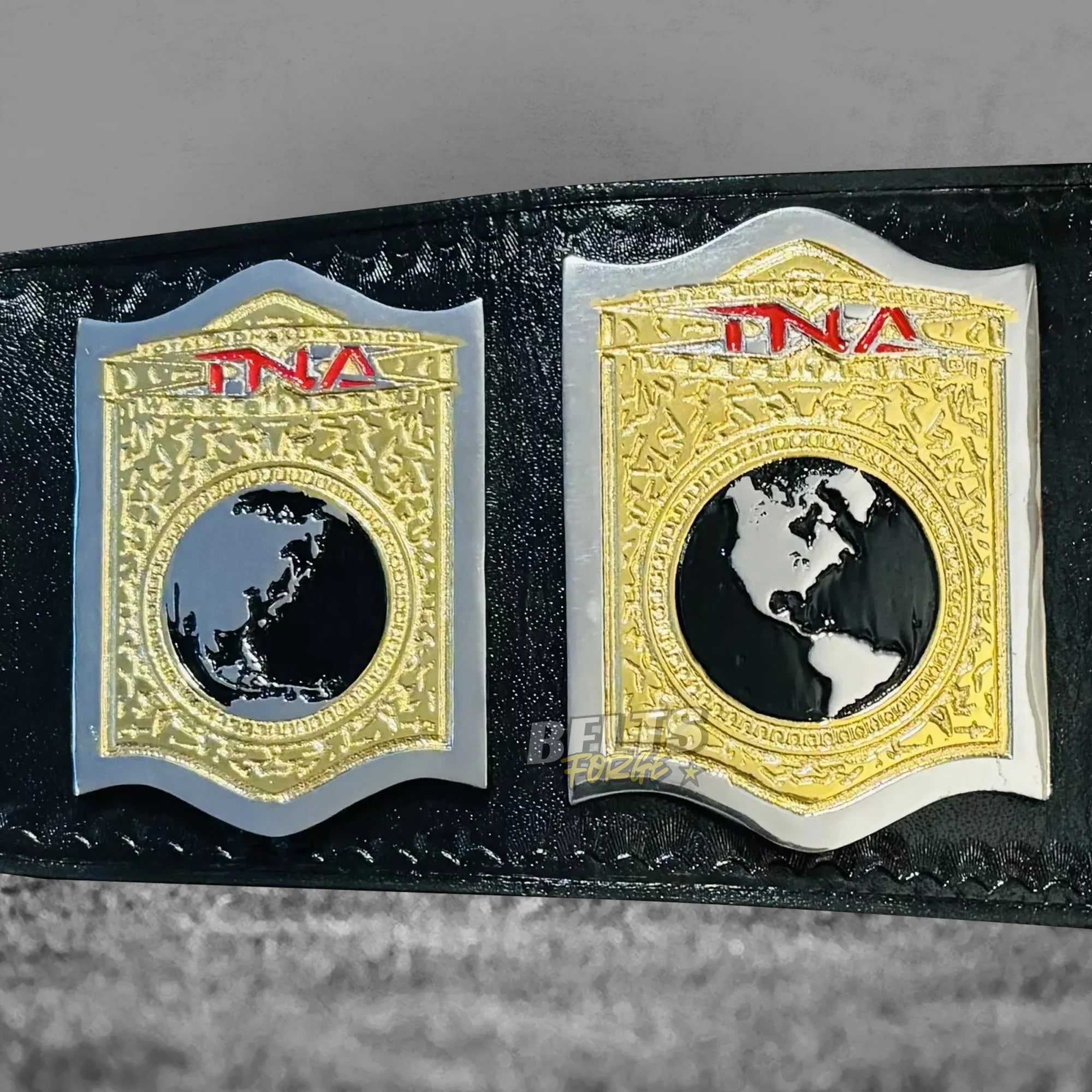 TNA World Tag Team Championship Belt side plates alternate detail showing gold brass TNA engraving and leather strap