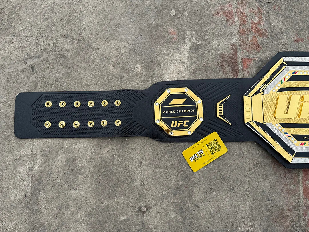 UFC Legacy Championship Belt left strap detail showing gold rivet studs, UFC World Champion side plate and black leather