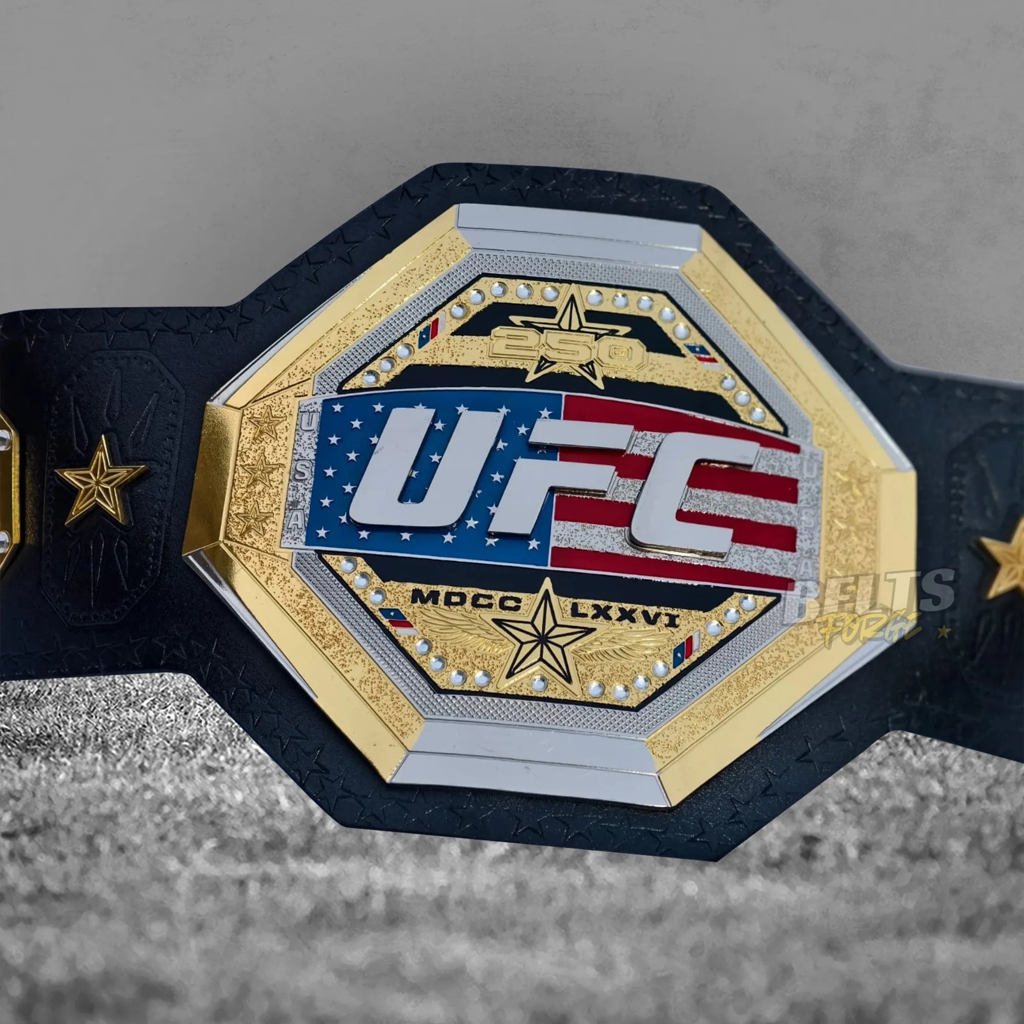 UFC Freedom 250 Championship Belt center plate close-up showing CNC-engraved gold-plated brass octagon design with crystal rhinestone border