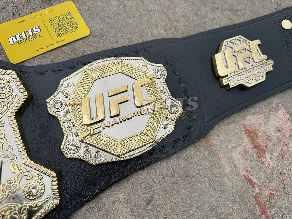 UFC Classic Championship Belt left side plate macro, gold octagon UFC Champion engraving with rhinestone accents