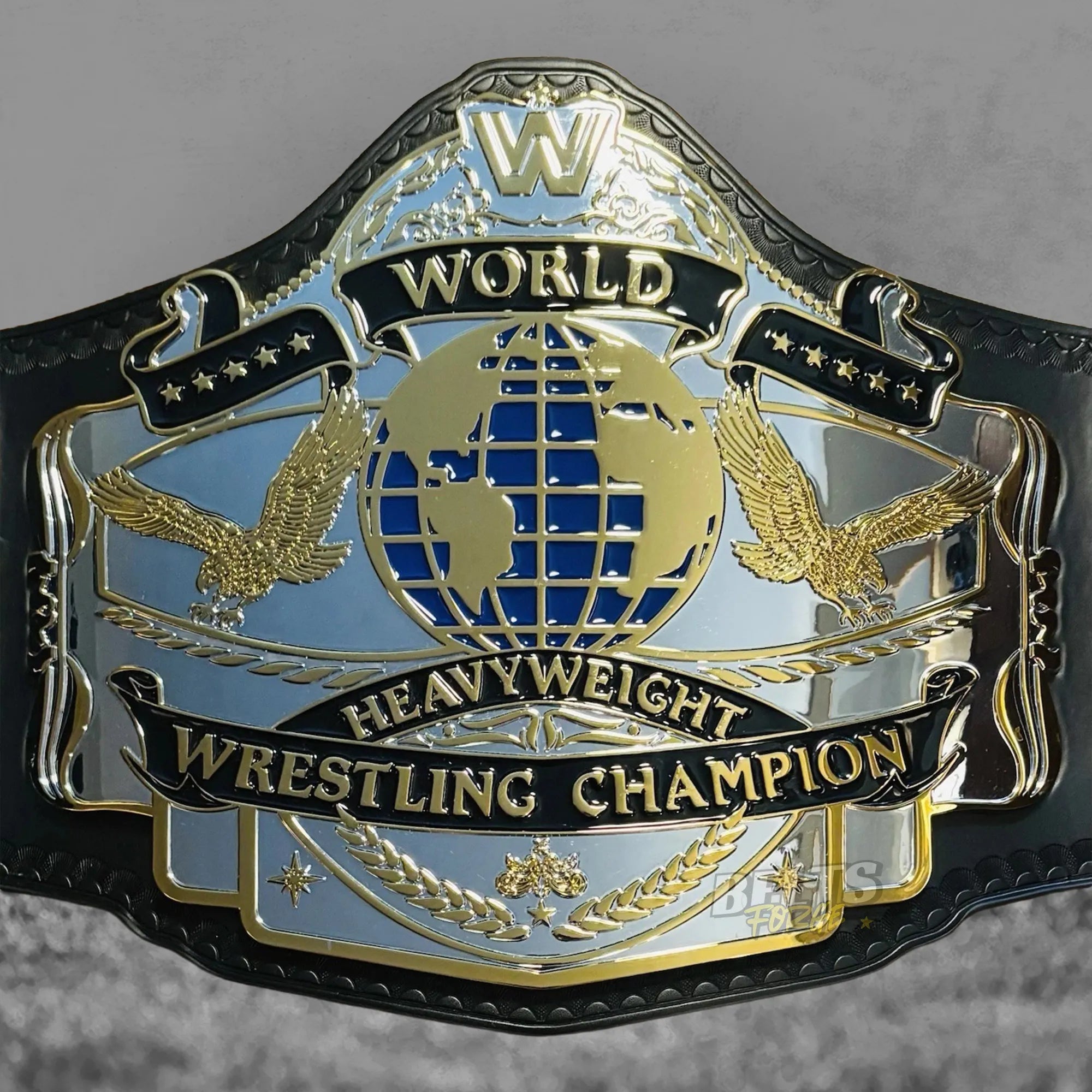 Golden Era 87 World Heavyweight Championship Belt center plate close-up showing CNC-engraved silver chrome-plated brass 1987 heavyweight design