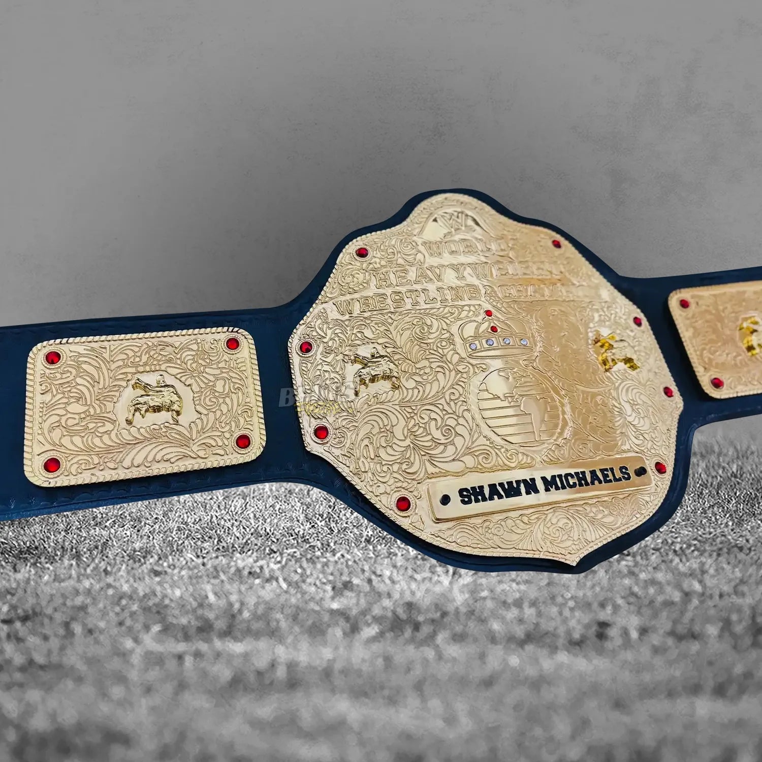 Big Gold Belt World Heavyweight Championship left side plate angled view showing gold-plated brass ornate eagle wing side plate detail