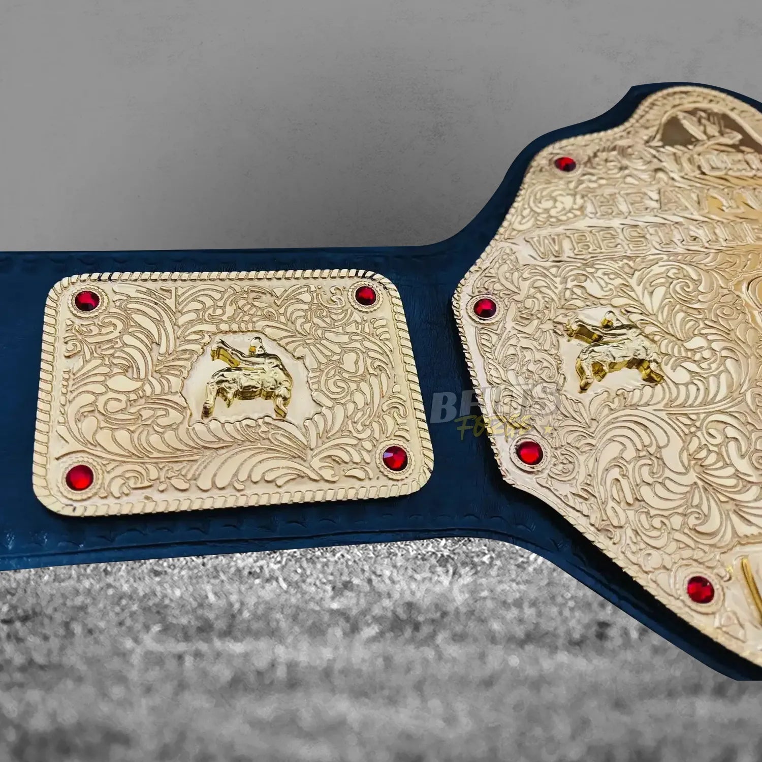 Big Gold Belt World Heavyweight Championship side plates detail close-up showing gold-plated brass ornate eagle wing engraving