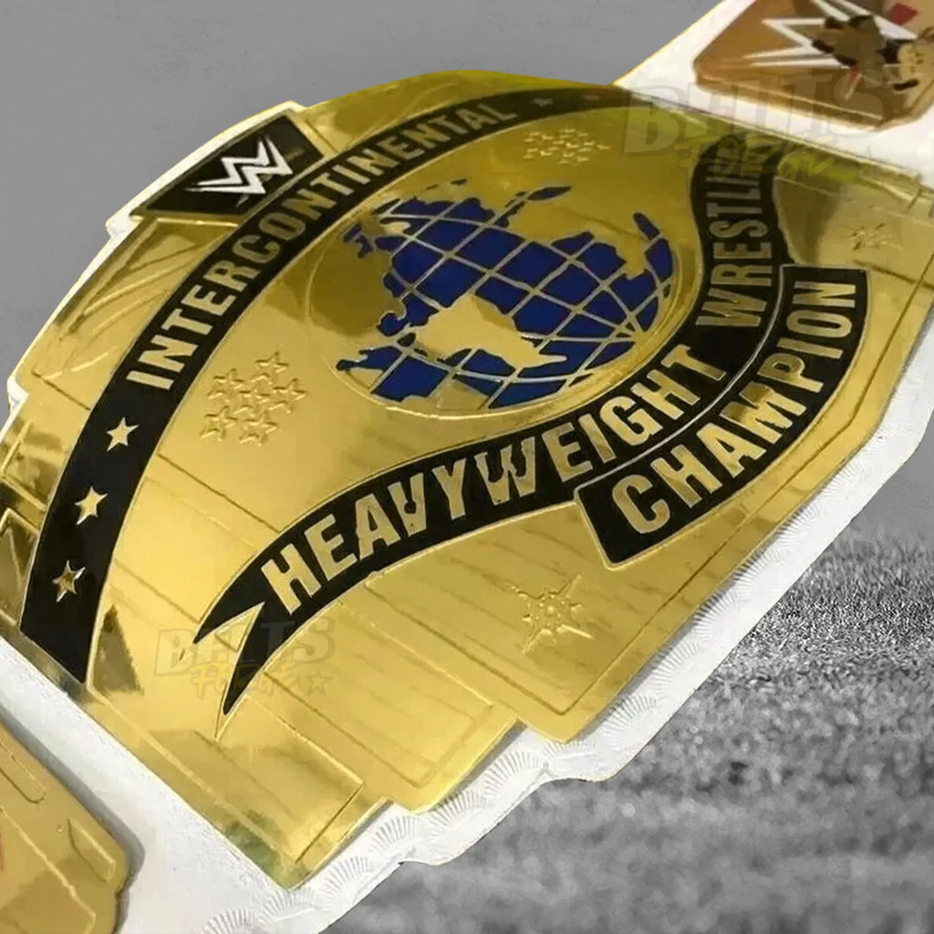 Intercontinental Championship Belt center plate angled close-up showing gold engraving and IC badge detail on white leather