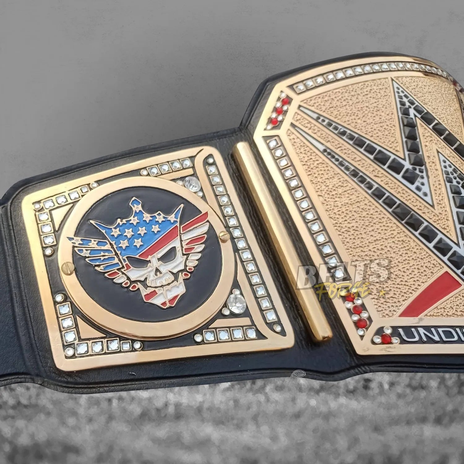 Cody Rhodes American Nightmare championship belt left side plate close-up showing gold-plated skull logo and genuine leather strap detail
