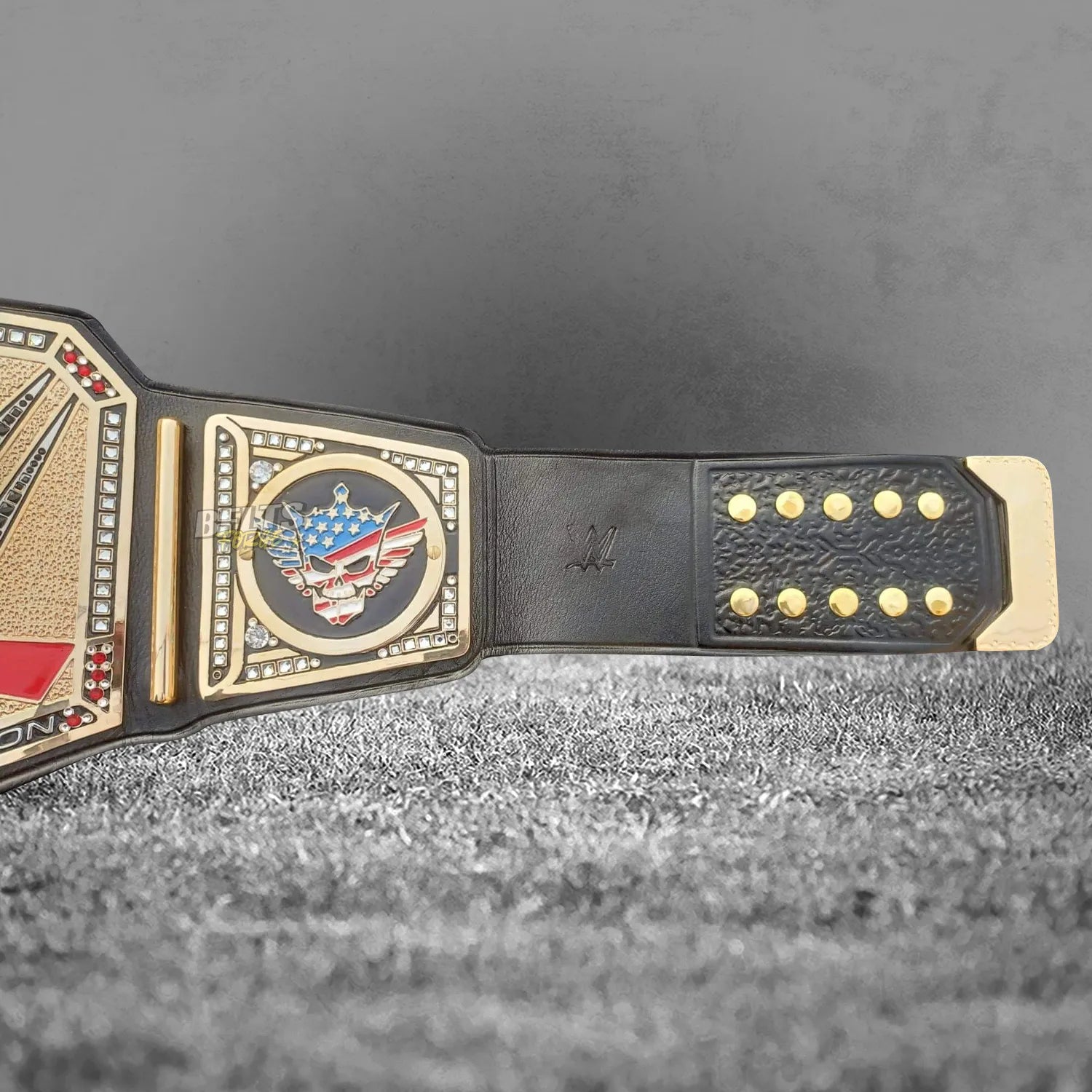 Cody Rhodes American Nightmare championship belt right strap end and skull logo side plate detail on genuine black leather strap