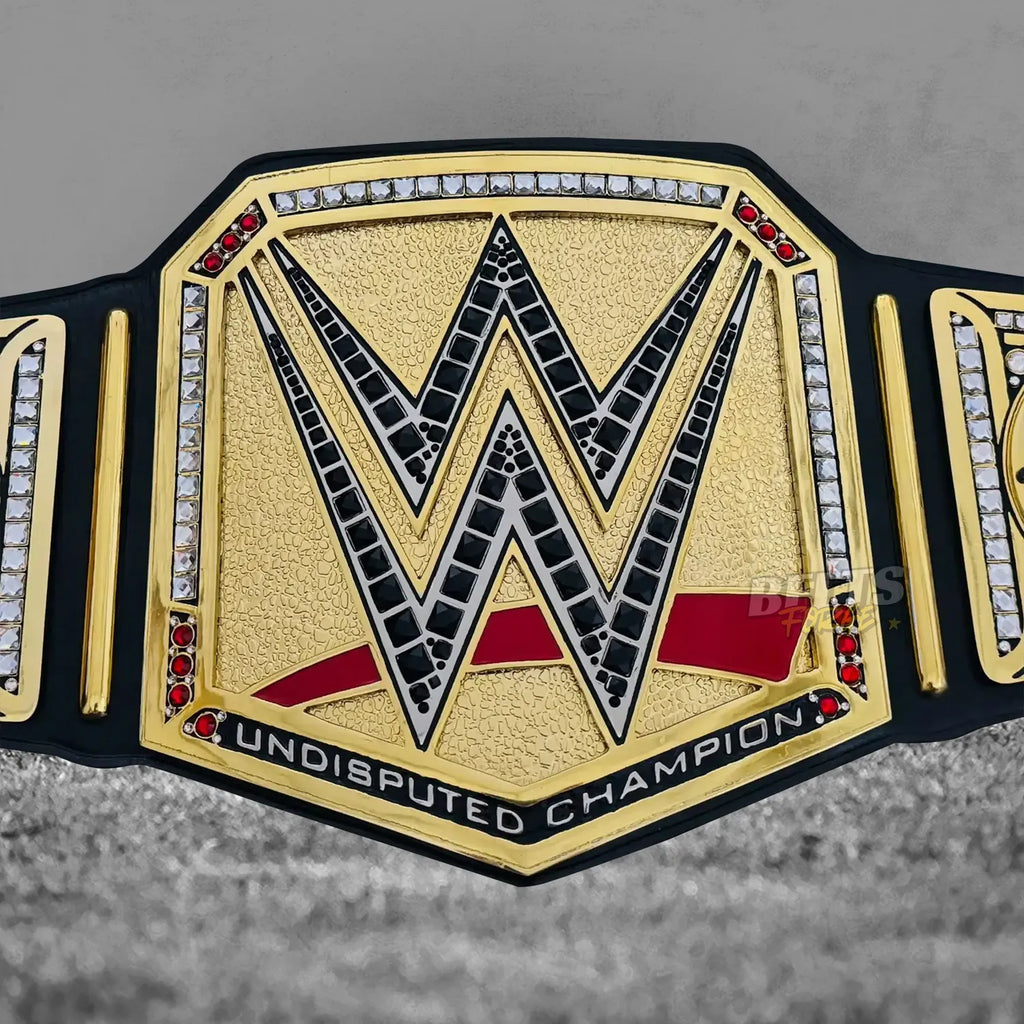 John Cena Undisputed Championship Farewell 2025 Belt center plate close-up showing CNC-engraved gold-plated brass Undisputed design