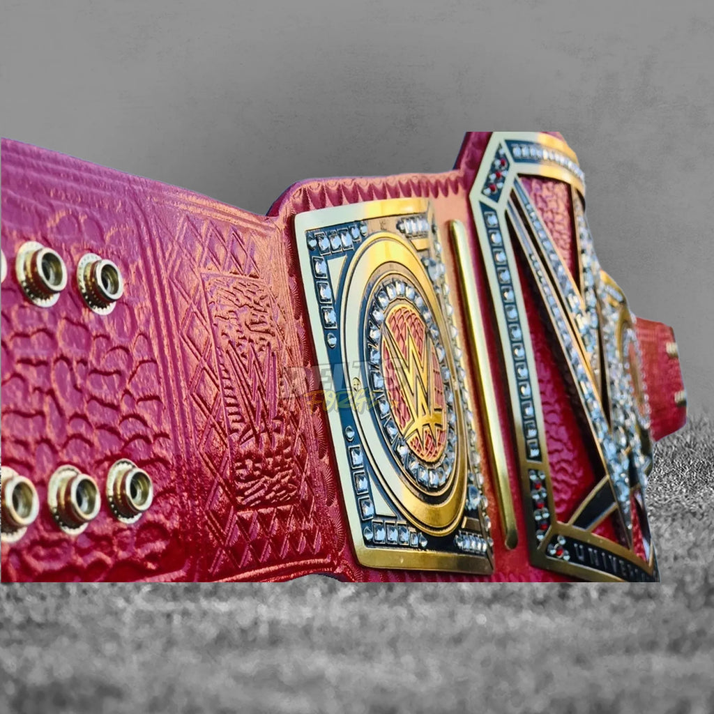 Pink Universal Championship Belt angled plate and strap view showing gold brass plates and pink leather strap profile