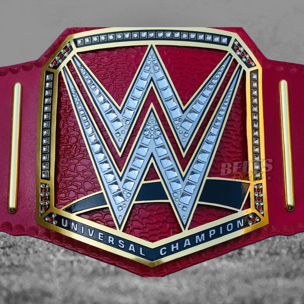 Pink Universal Championship Belt center plate detail showing CNC-engraved gold-plated brass Universal Championship globe design