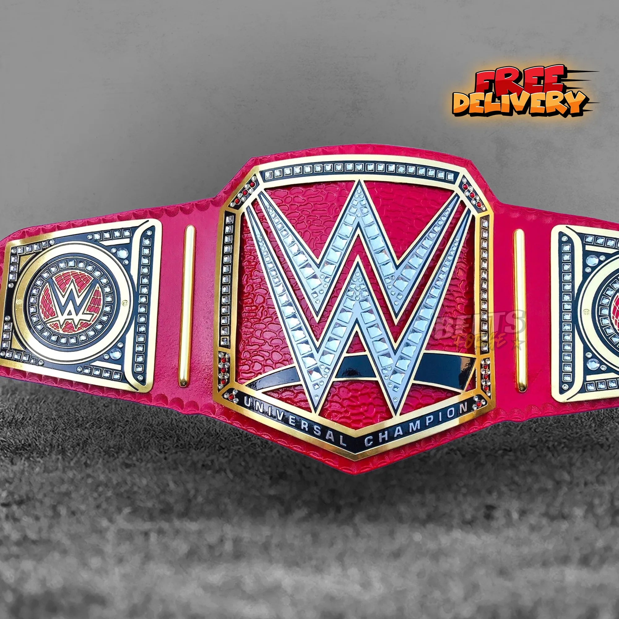 Pink Universal Championship Belt replica front view, gold-plated brass globe plates on genuine pink leather strap with gold rivets by Belts Forge