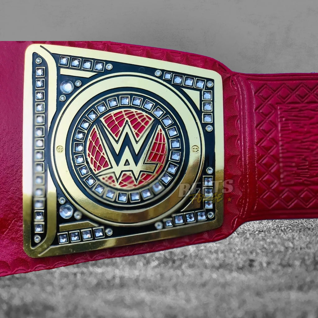 Pink Universal Championship Belt side plate detail showing gold-plated brass side plate on genuine pink leather strap