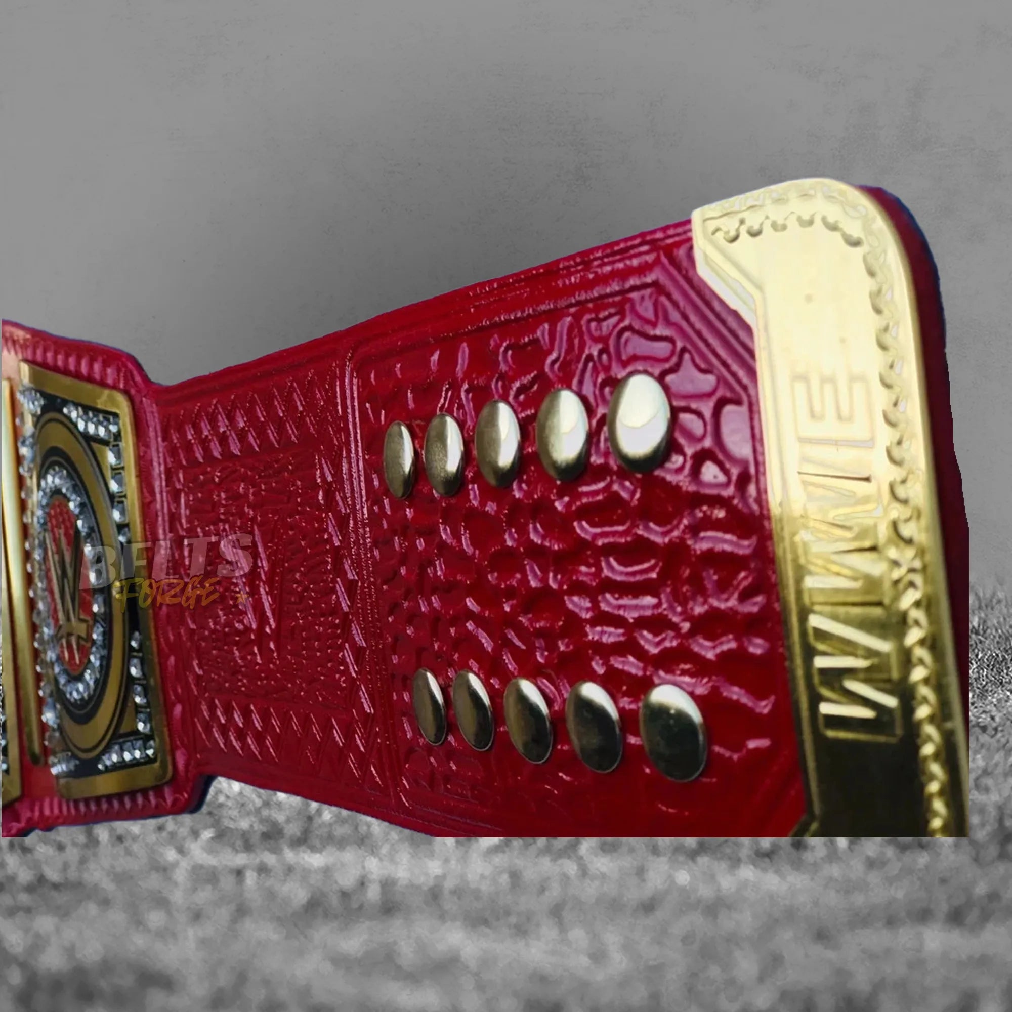 Pink Universal Championship Belt strap rivet detail showing gold rivet studs on genuine pink leather strap