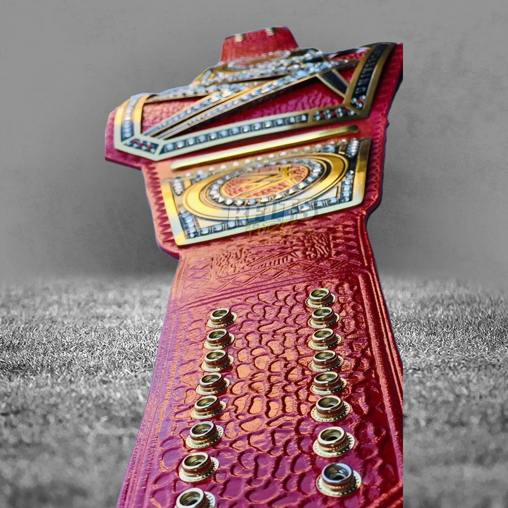 Pink Universal Championship Belt strap tip back detail showing gold hardware and genuine pink leather texture close-up