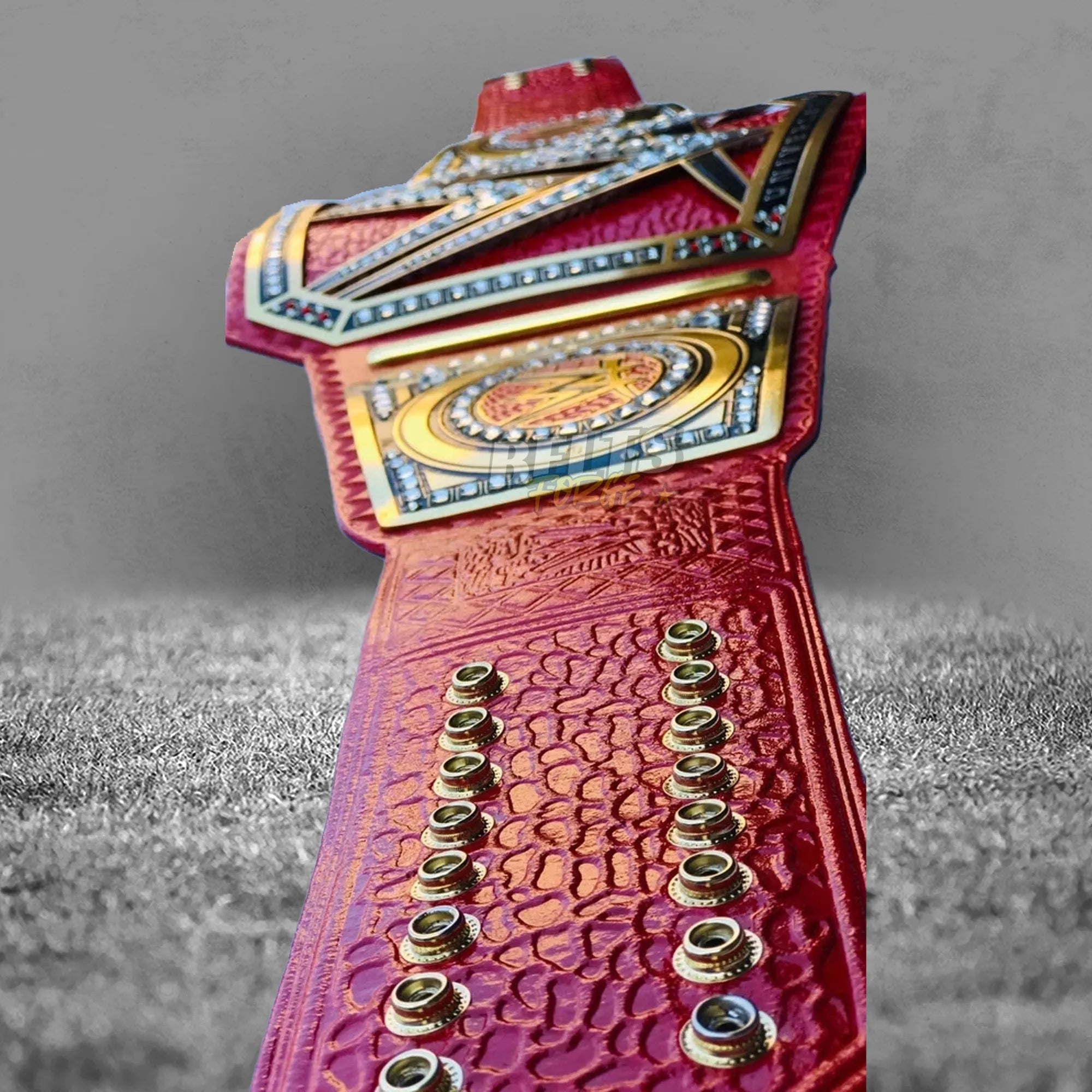 Pink Universal Championship Belt strap tip back detail showing gold hardware and genuine pink leather texture close-up