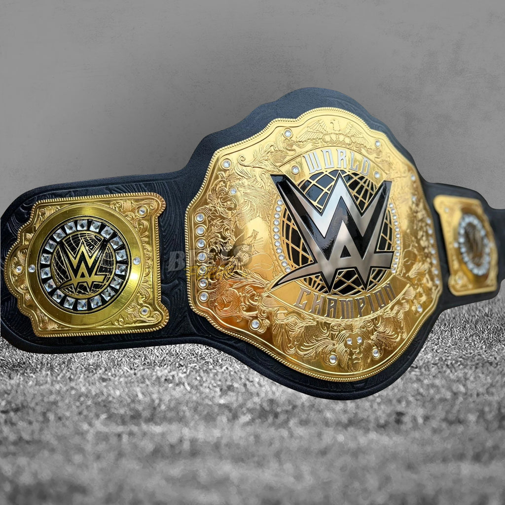 WWE World Heavyweight Championship Belt replica angled left view showing gold WWE logo plate, rhinestone crystal border and left square side plate with globe logo