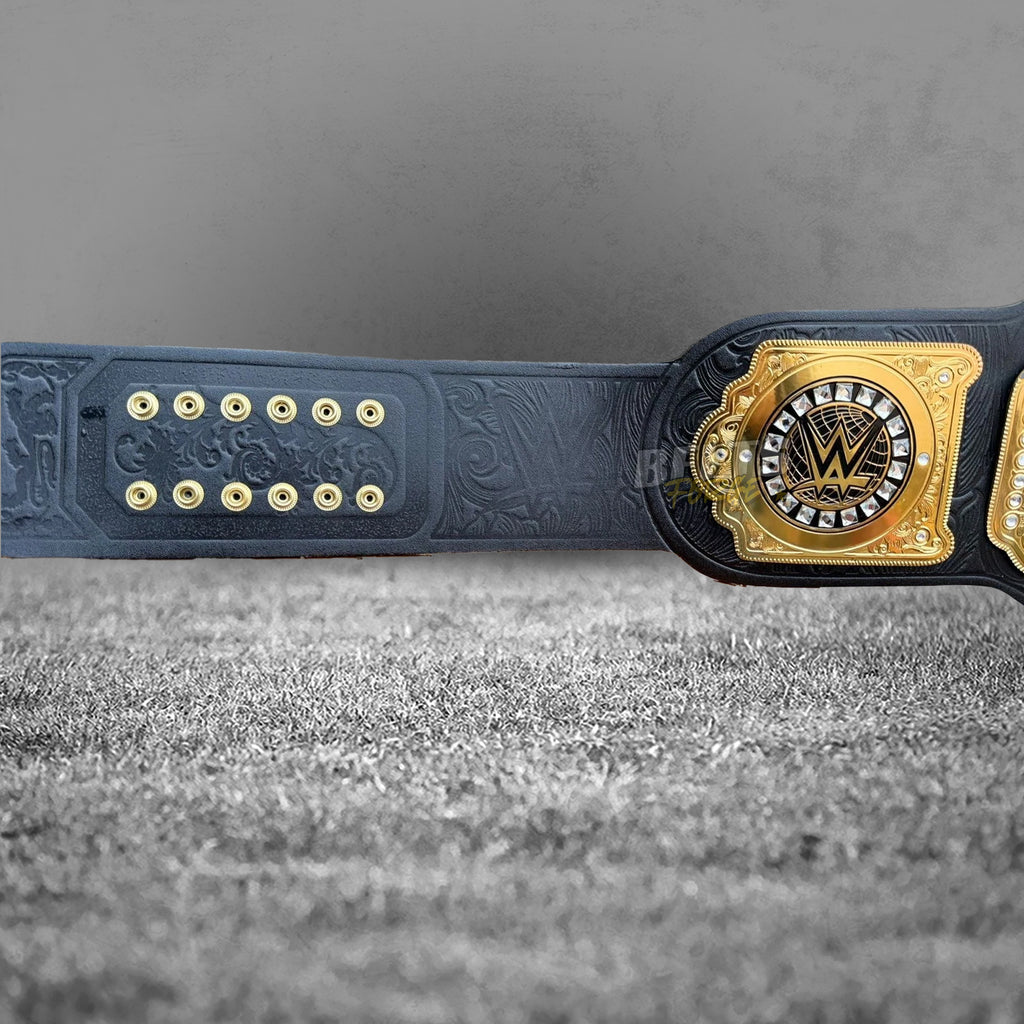 WWE World Heavyweight Championship Belt back strap detail showing deep floral embossed genuine black leather, gold studs and square side plate close-up