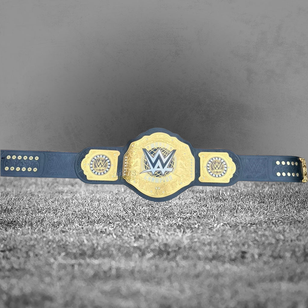 WWE World Heavyweight Championship Belt replica full length flat lay, 52 inch genuine leather strap with gold-plated brass plates and square side plates by Belts Forge