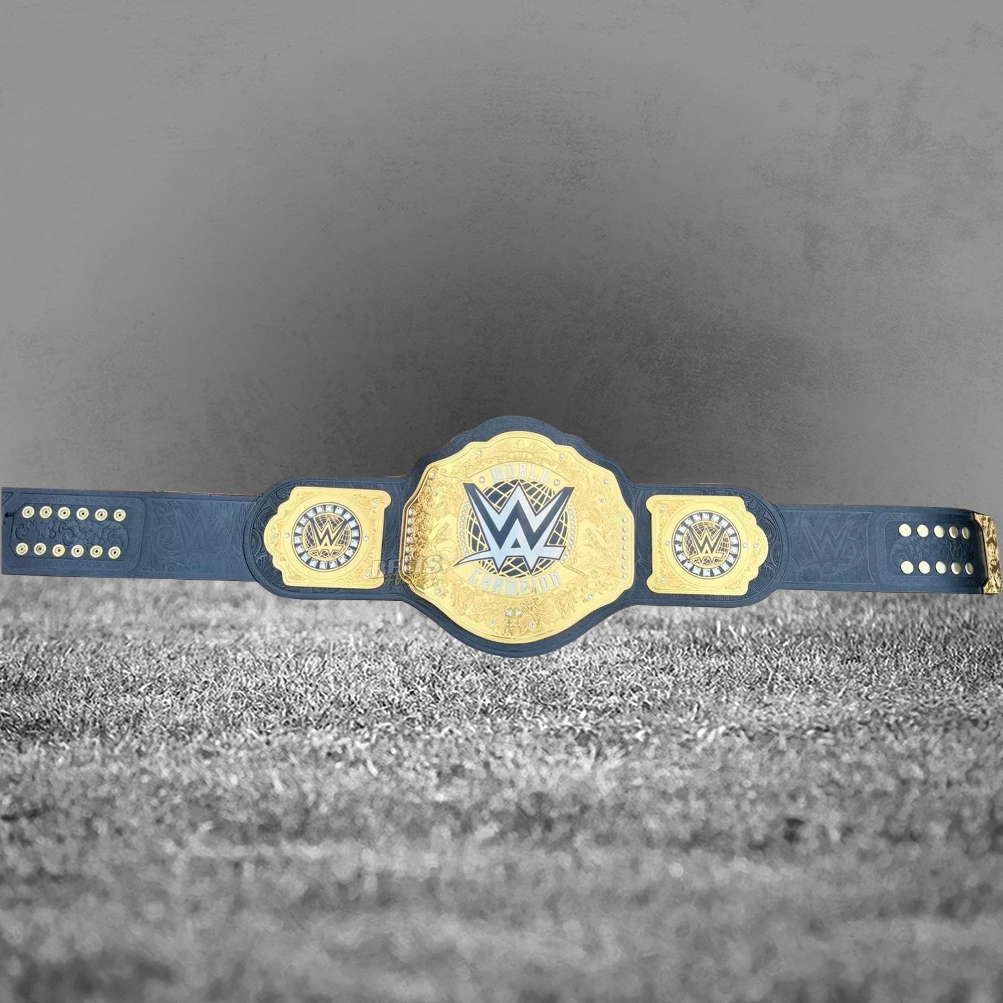 WWE World Heavyweight Championship Belt replica full length flat lay, 52 inch genuine leather strap with gold-plated brass plates and square side plates by Belts Forge