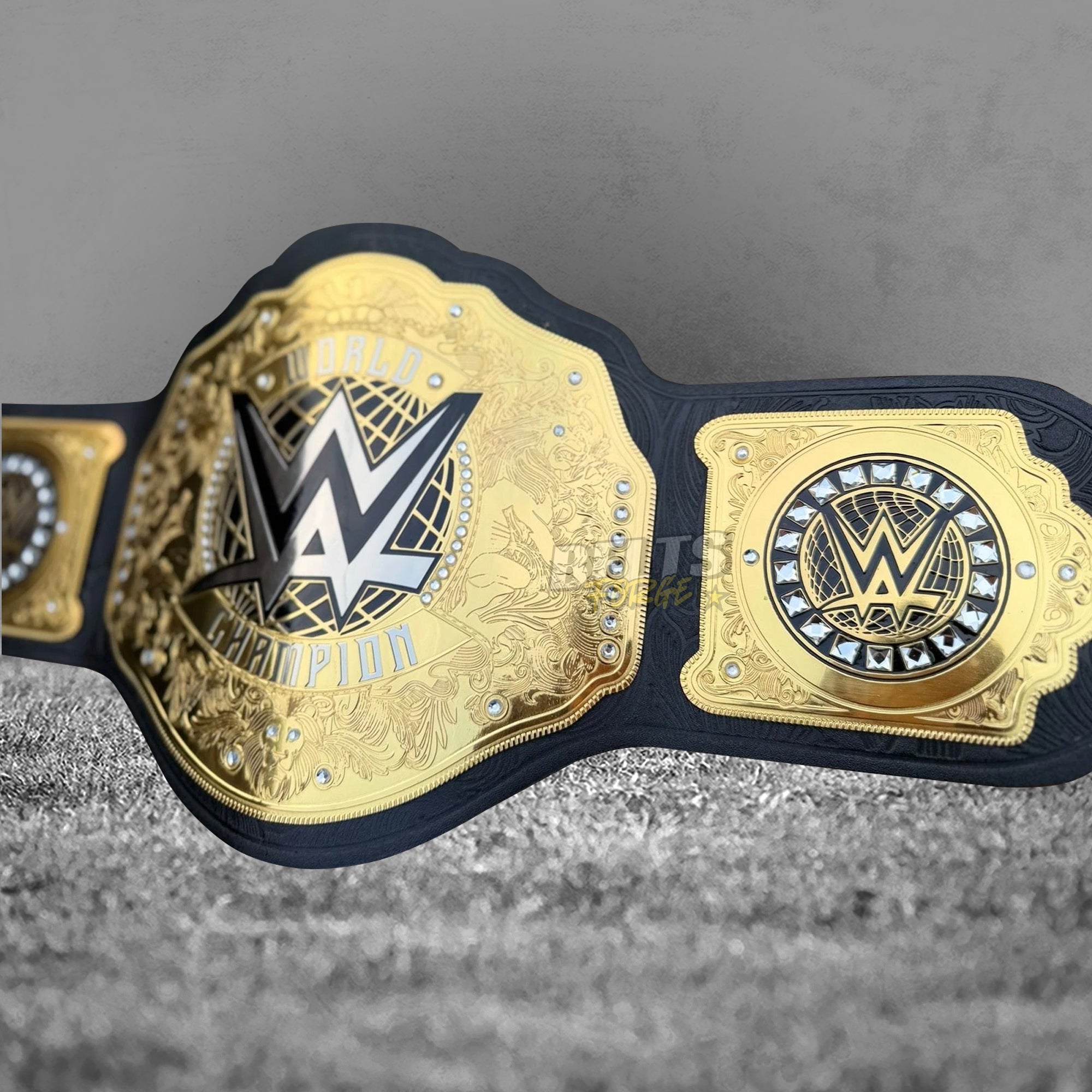 WWE World Heavyweight Championship Belt right side plate and main plate angled view, gold WWE World Champion engraving with crystal border and floral embossed leather