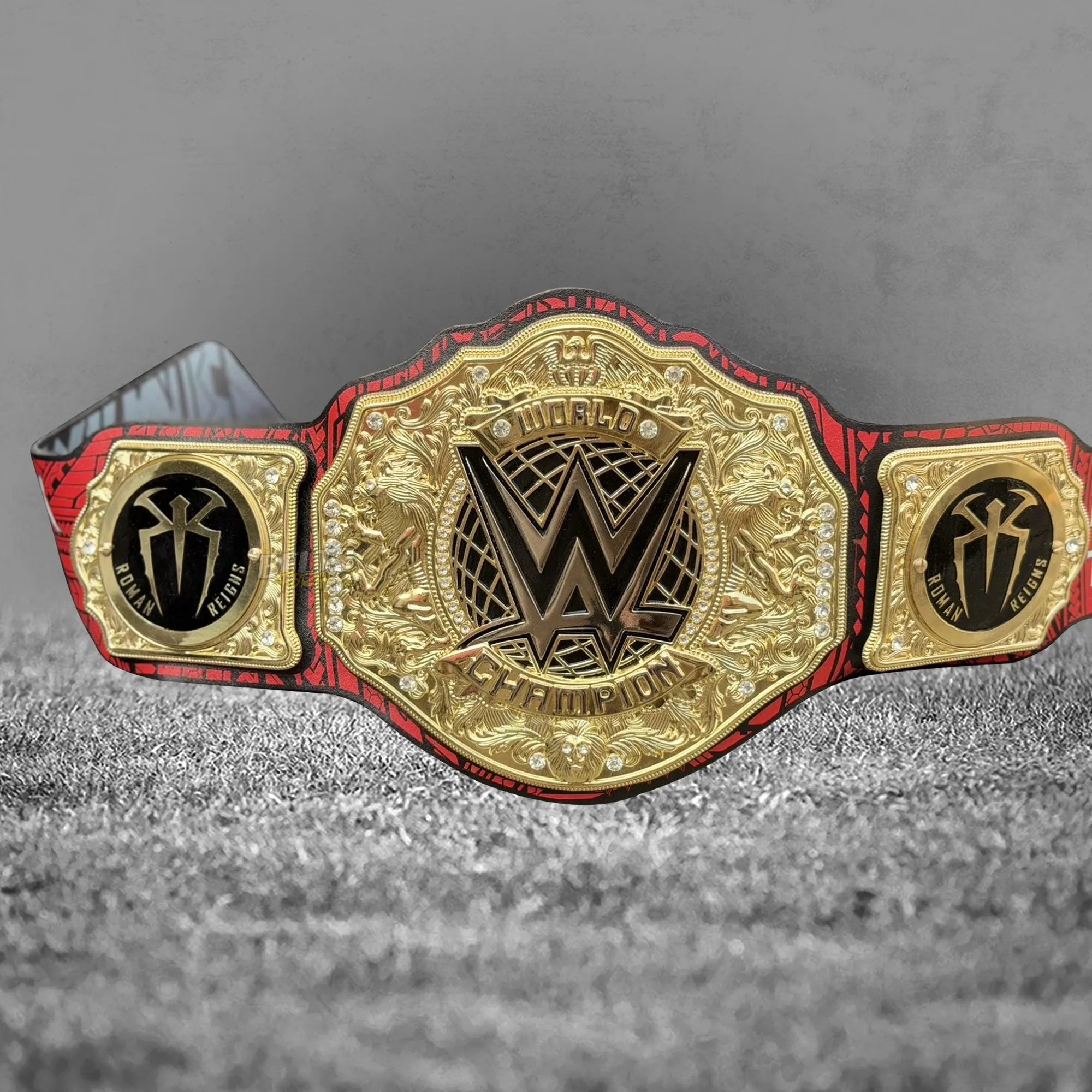Roman Reigns Head of the Table championship belt angled center plate view showing gold tribal brass engraving detail