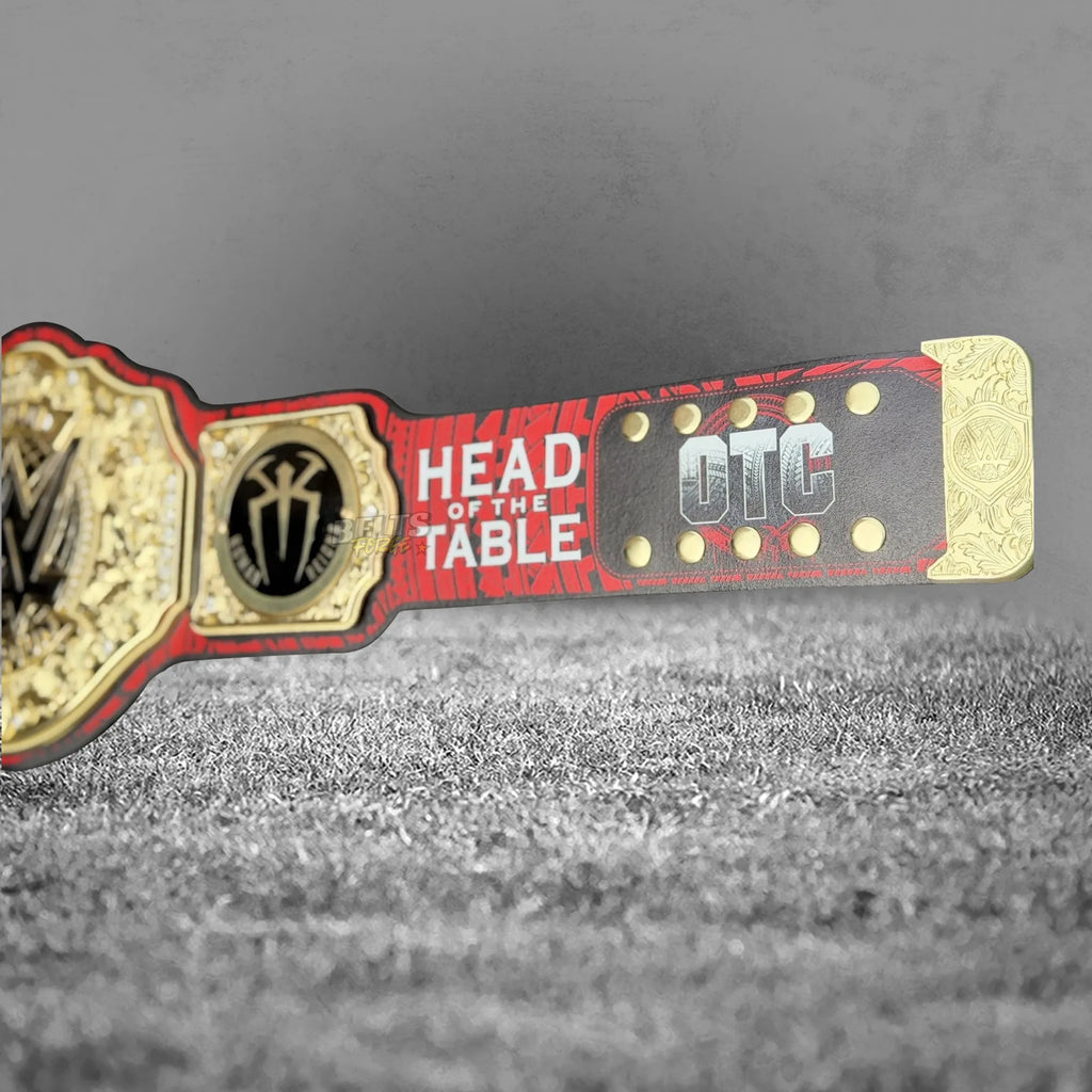Roman Reigns plate close-up showing gold-plated brass tribal shield design and Head of the Table inscription engraving