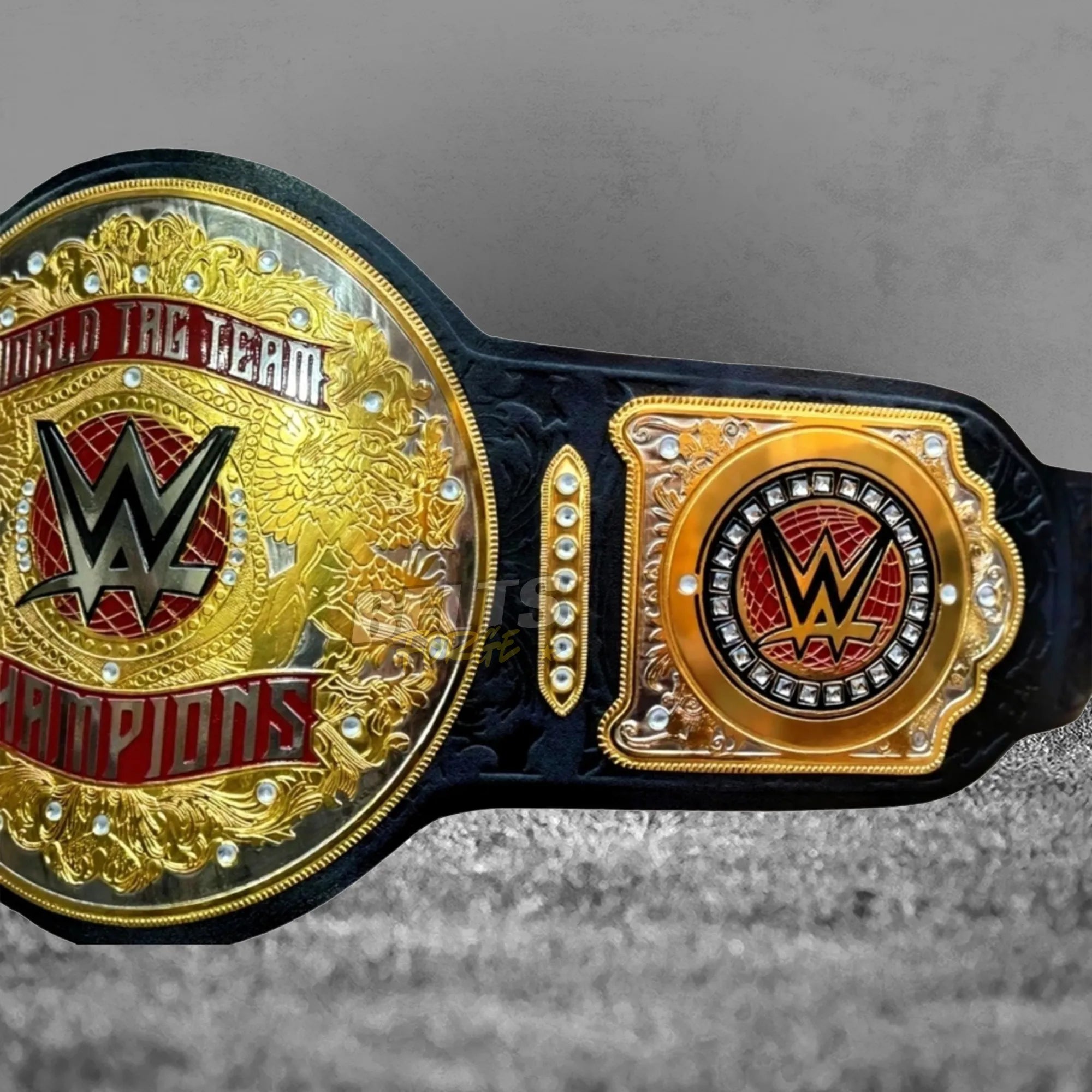 World Tag Team Championship Belt center and side plate close-up showing CNC-engraved gold-plated brass globe and side plate detail