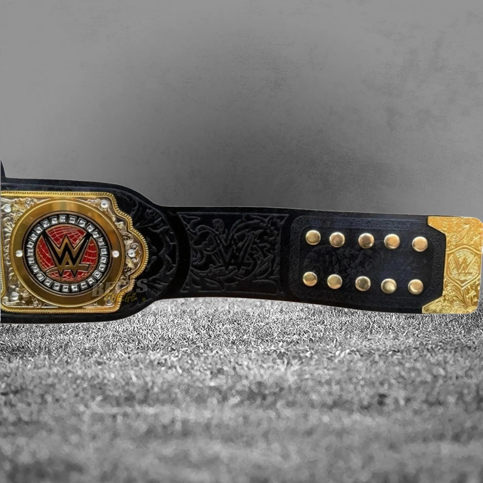 World Tag Team Championship Belt strap rivet and side plate view showing gold hardware and gold-plated brass side plate on leather