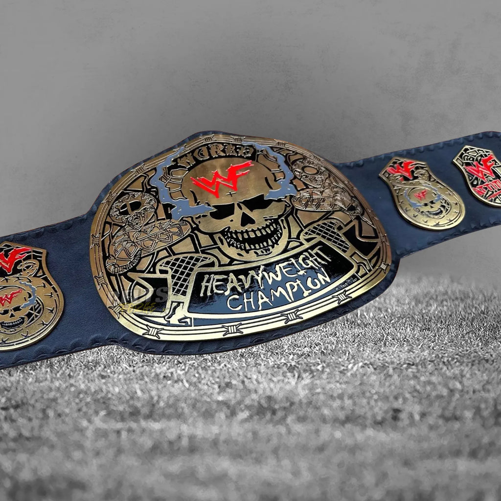 Skull Era Heavyweight Championship Belt center plate angled close-up showing CNC engineered gold-plated brass skull design
